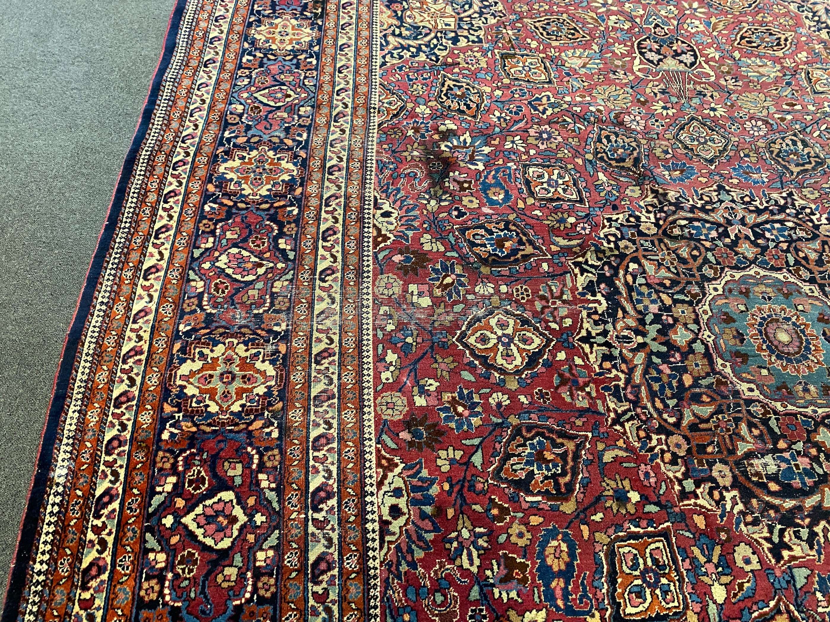 An early 20th century Heriz burgundy ground carpet